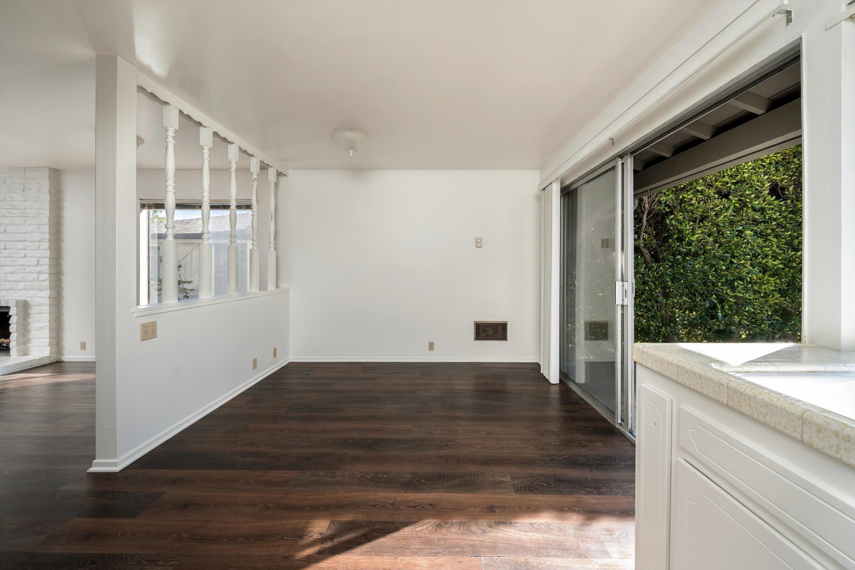 475 Linfield Place Goleta, CA 93117 - Photo 7 of 25 a view of a hallway with wooden floor and a kitchen
