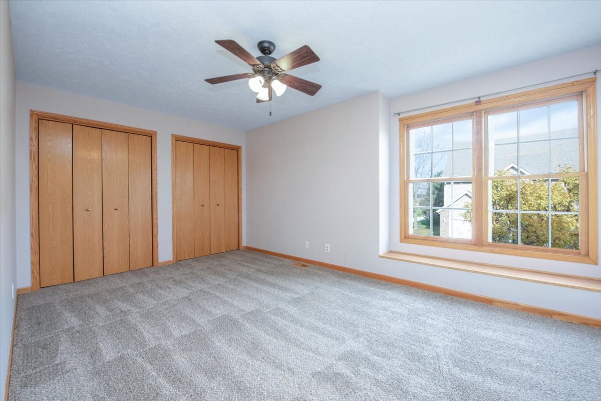 480 South Peace Road Sycamore, IL 60178 - Photo 12 of 22 a view of an empty room with chandelier fan and fire place