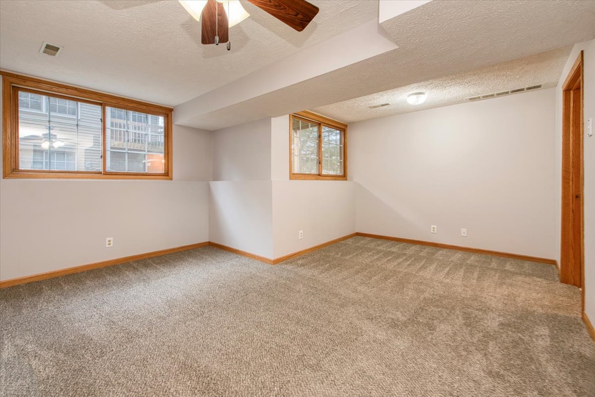 480 South Peace Road Sycamore, IL 60178 - Photo 19 of 22 an empty room with chandelier fan and windows
