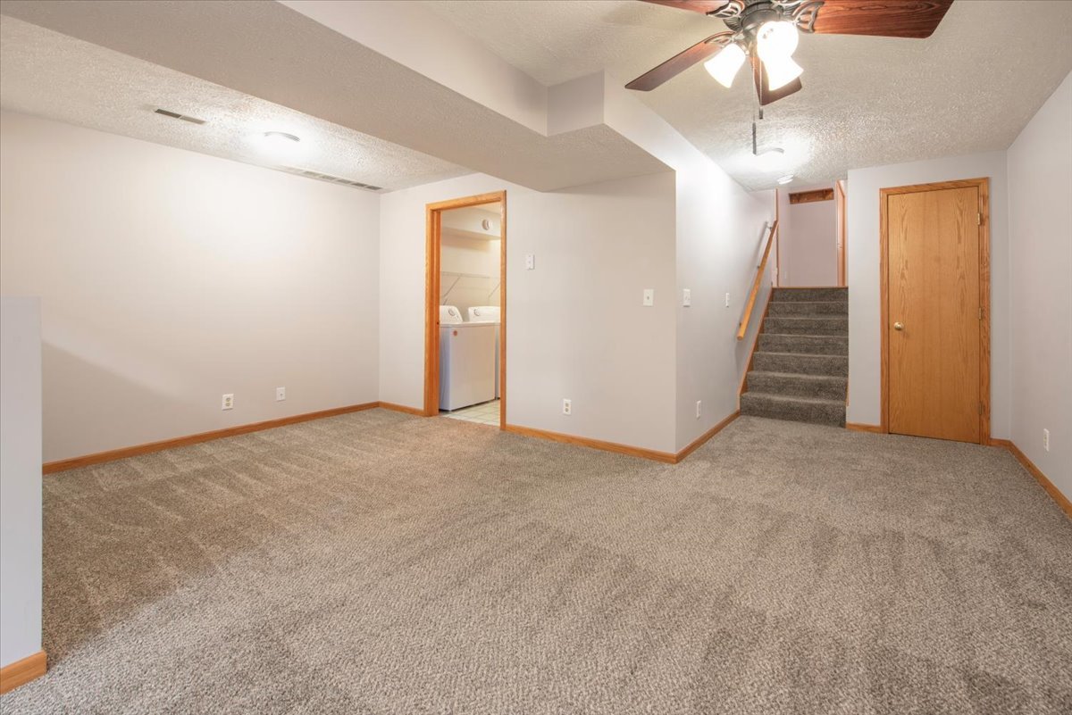 480 South Peace Road Sycamore, IL 60178 - Photo 20 of 22 an empty room with a chandelier fan and closet area