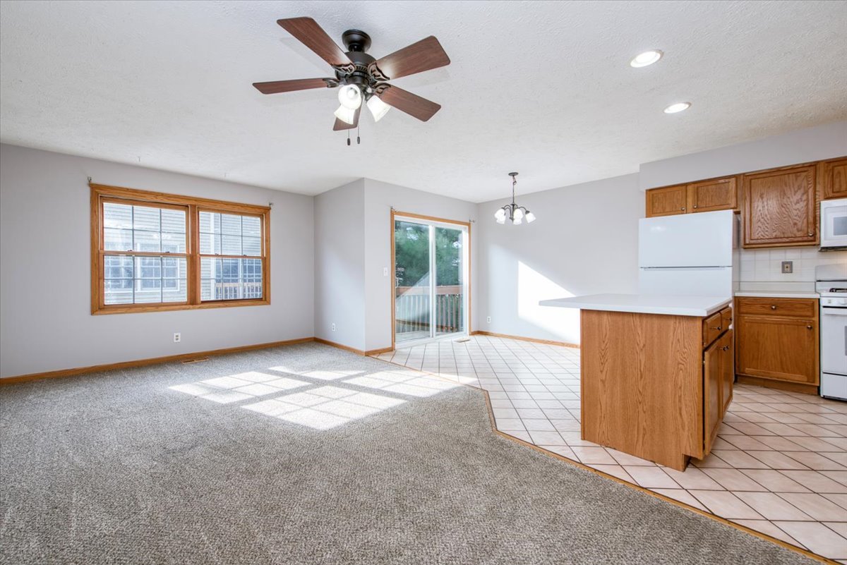 480 South Peace Road Sycamore, IL 60178 - Photo 4 of 22 a view of livingroom and kitchen with hardwood floor and a ceiling fan