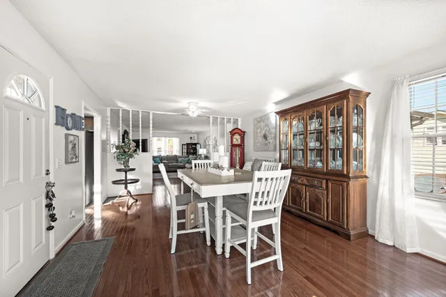 a view of a dining room with furniture and wooden floor