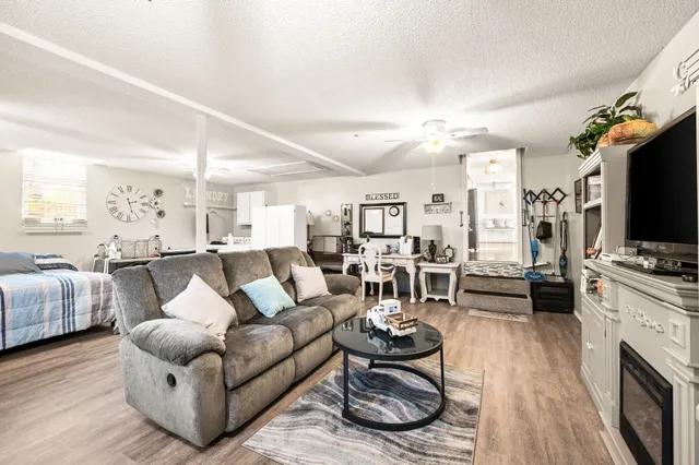 a living room with furniture flat screen tv and couches