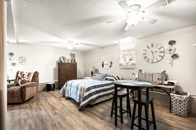 a bedroom with a bed and a table with rug