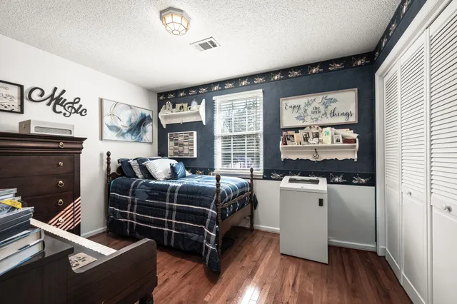 a bed room with furniture and a flat screen tv