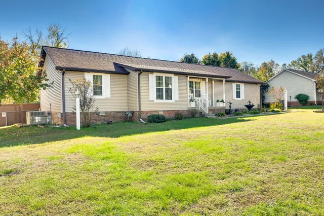 a front view of house with yard and green space