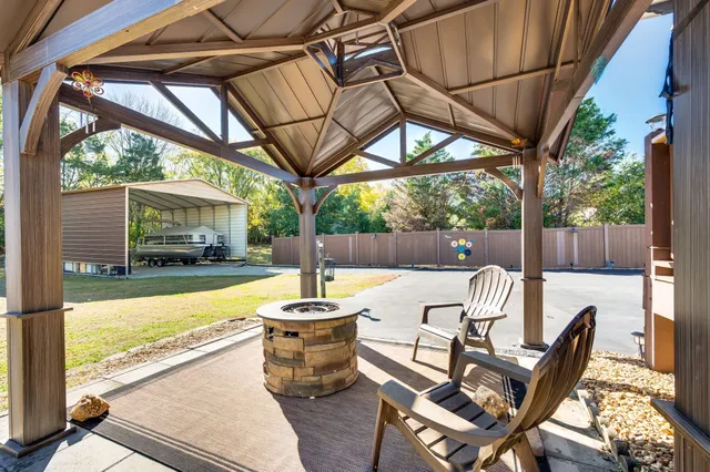 a view of a house with backyard and sitting area