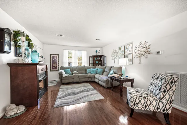 a living room with furniture and wooden floor