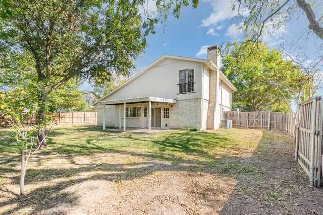 a big house with a big yard and large trees
