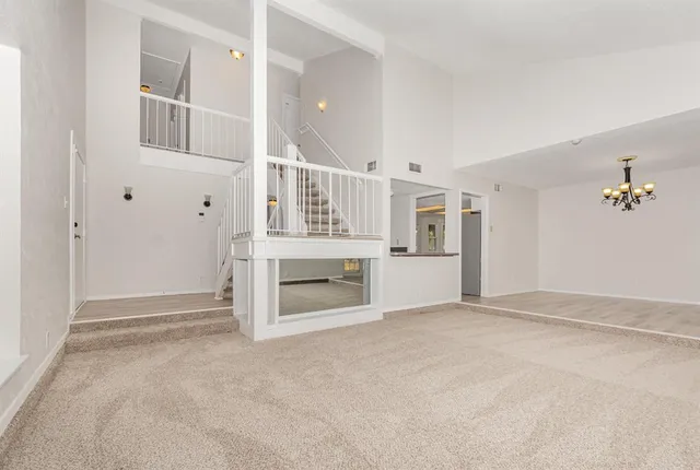 an empty room with windows and pillars in it