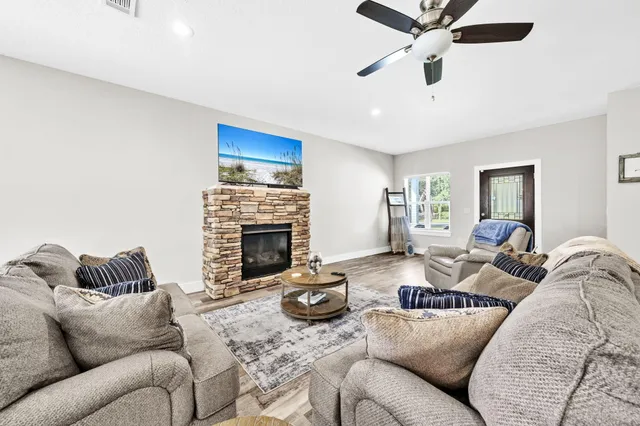 a living room with furniture and a fireplace