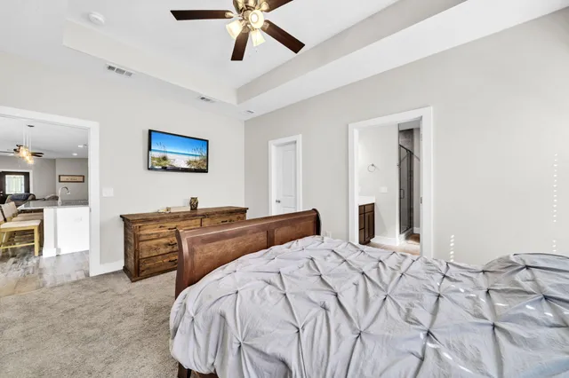 a bedroom with a bed and a chandelier