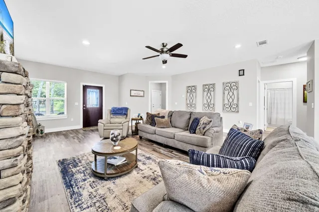 a living room with furniture and wooden floor