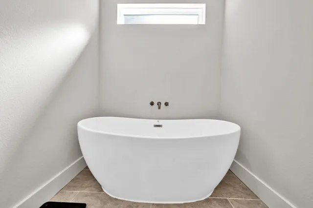 a white bath tub sitting in a bathroom