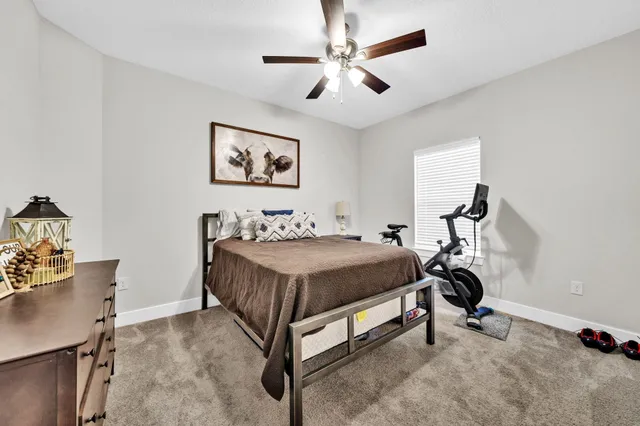 a bedroom with a bed and a desk