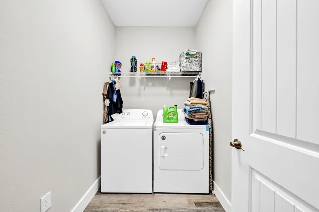 a view of storage and utility room with washer and dryer
