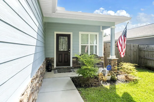 a balcony with furniture and a potted plant