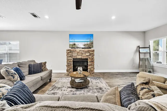 a open dining room with stainless steel appliances kitchen island granite countertop a table and chairs in it
