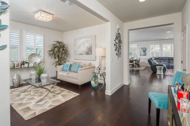 a living room with furniture and a large window with rug
