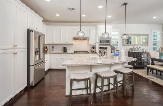 a large kitchen with kitchen island a large island in the center