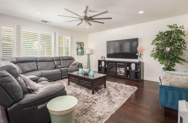 a living room with furniture wooden floor and a window