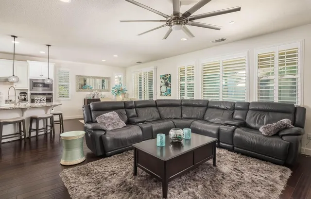 a view of a living room kitchen and a wooden floor