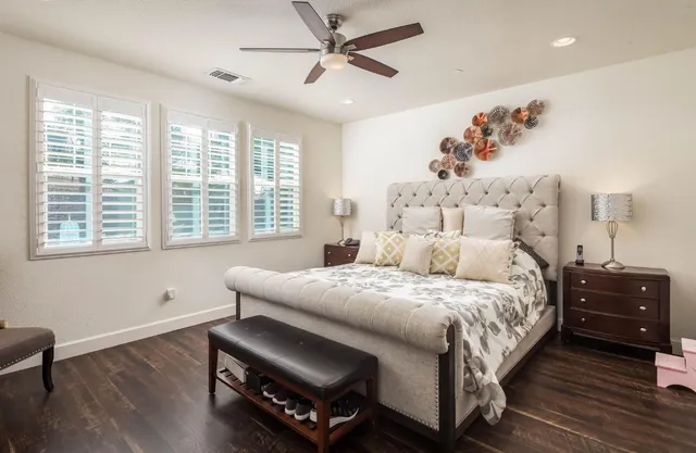a bedroom with a bed and wooden floor