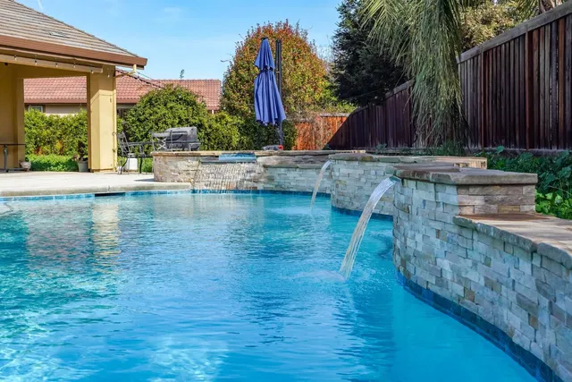 a view of swimming pool with wooden fence