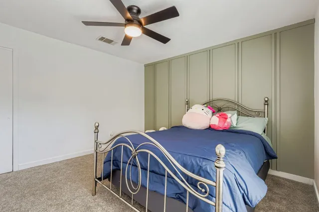 a view of a hallway with a dining table chairs