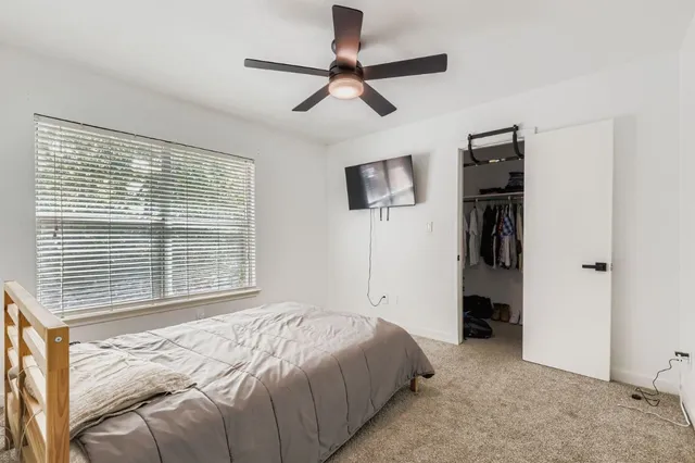 a bedroom with a bed and a television