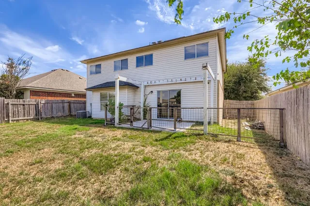 a view of a house with backyard and sitting area