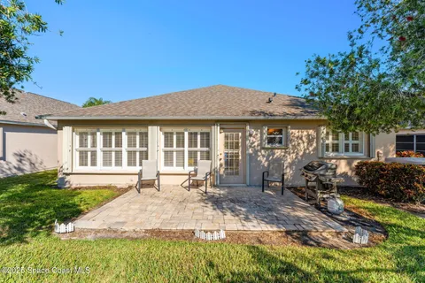 a front view of a house with a garden and patio