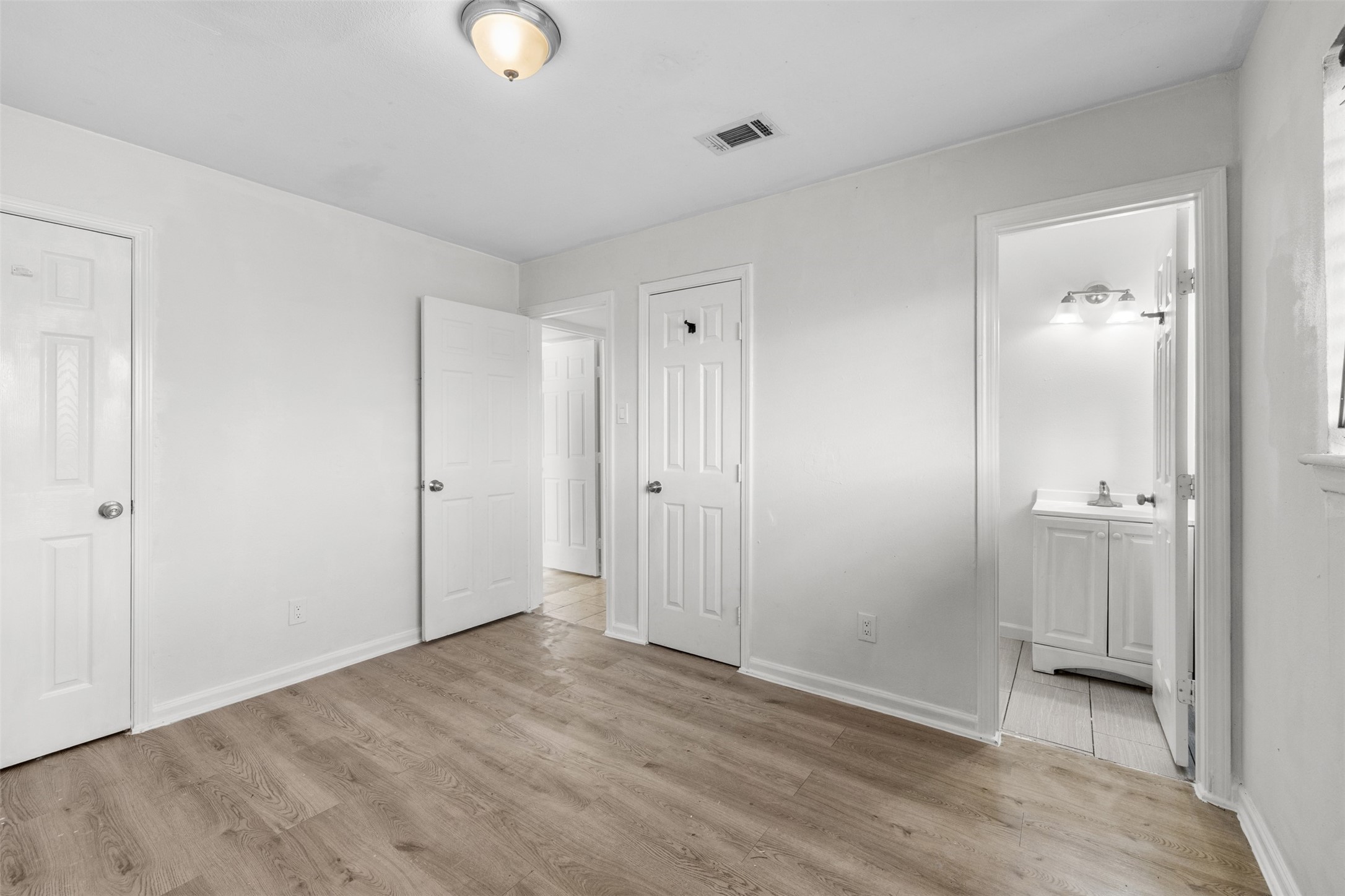 9802 Lum Lane Houston, TX 77078 - Photo 20 of 45 Primary bedroom facing hallway with a half bath
