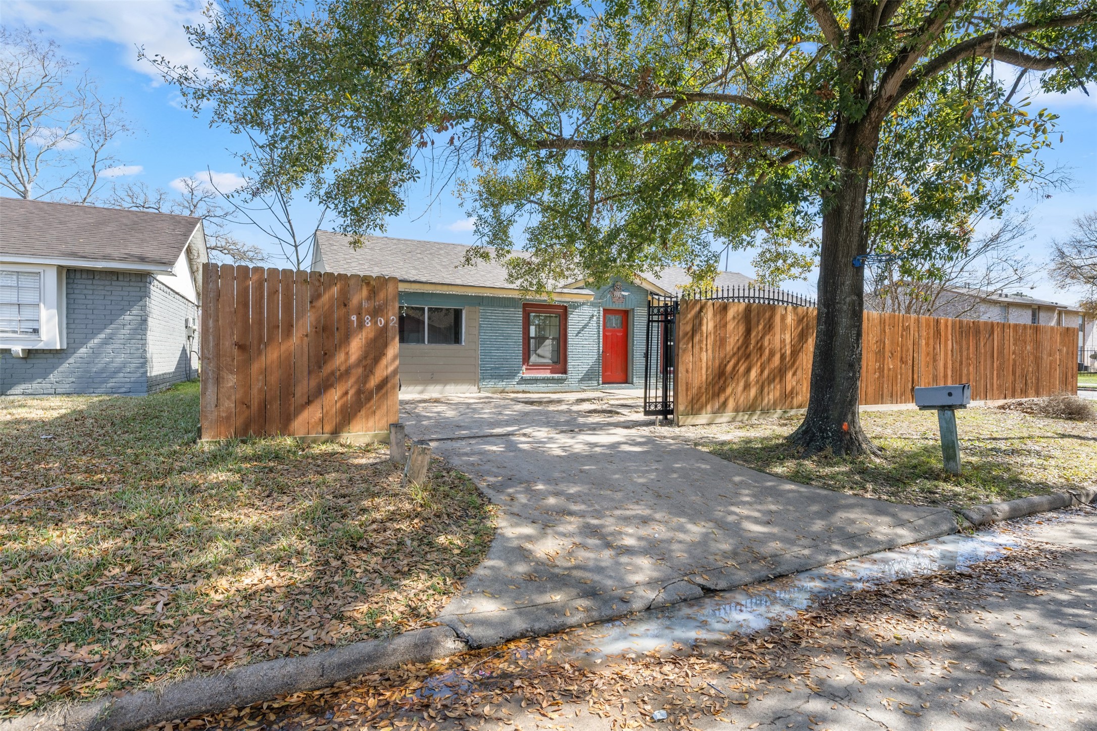 9802 Lum Lane Houston, TX 77078 - Photo 42 of 45 Street view of main home driveway with privacy fence and steel gate