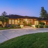 a front view of a house with a yard and outdoor seating