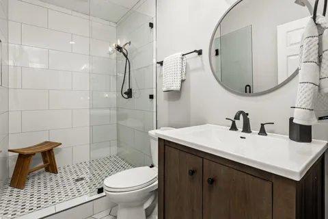 a bathroom with a sink toilet and shower