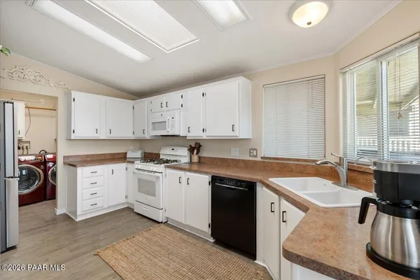 a kitchen with a stove a sink and a refrigerator