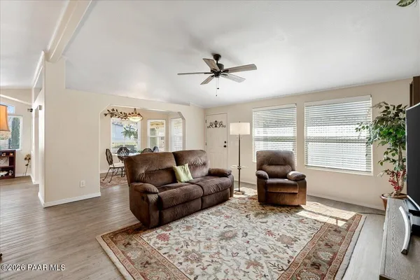 a living room with furniture windows and a table