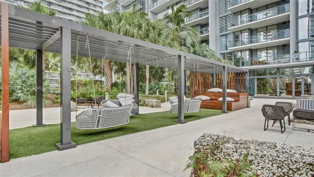 a building outdoor space with patio couch and glass windows