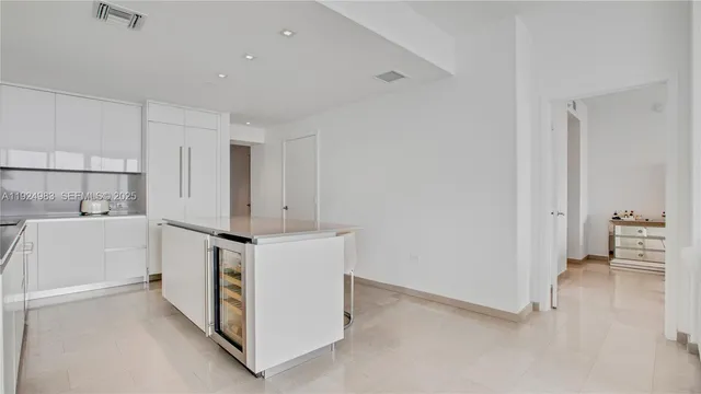 a kitchen with white cabinets and white appliances