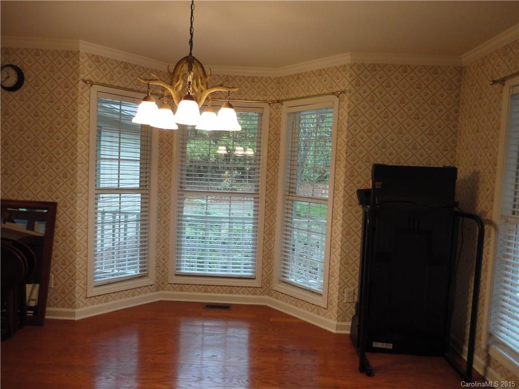 2675 Island View Road, Unit 1 Fort Mill, SC 29708 - Photo 23 of 24 a view of a room with wooden floor a ceiling fan and a window
