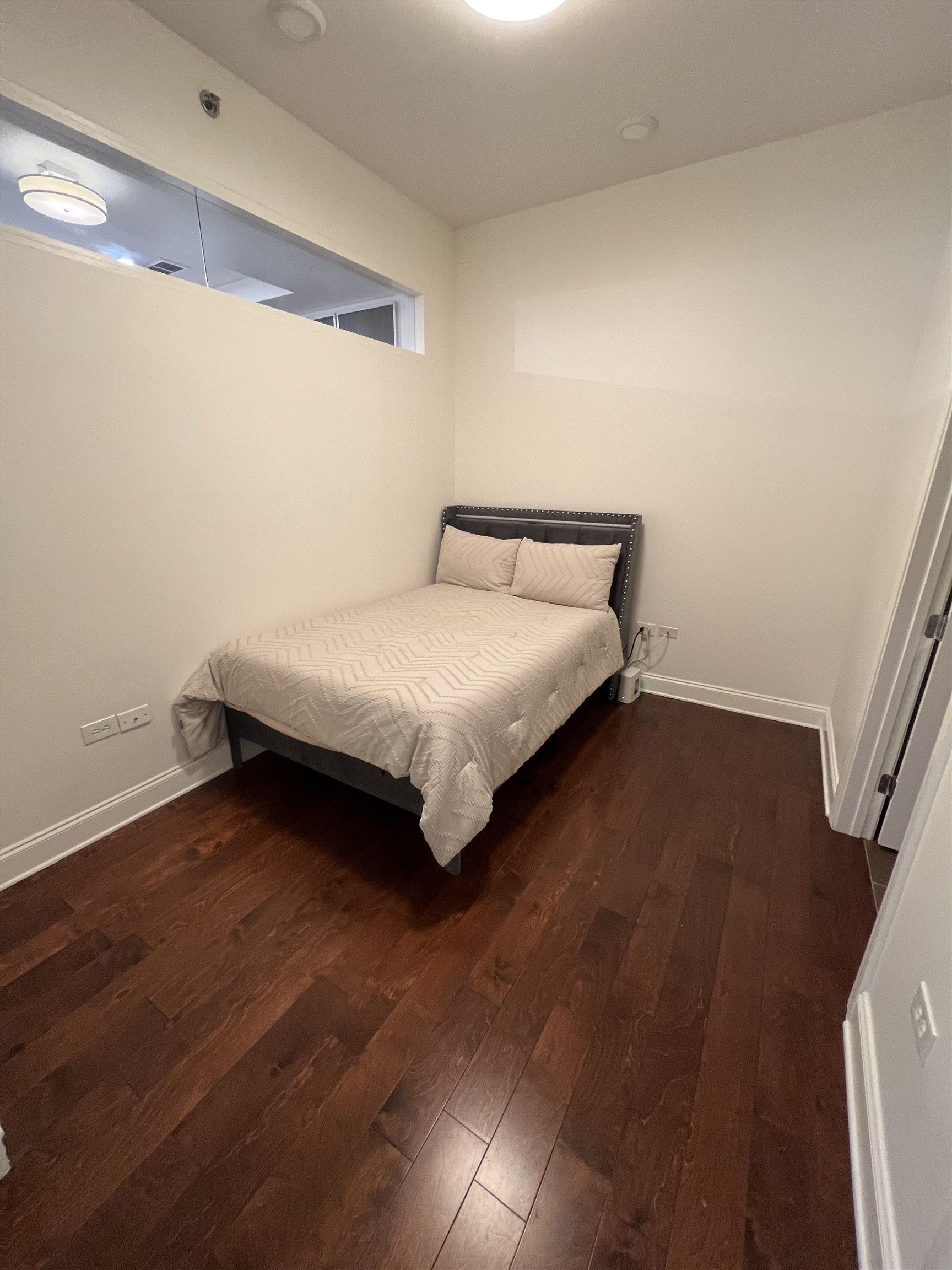 717 Riverside Drive, Unit 505 Memphis, TN 38103 - Photo 20 of 24 a bedroom with a bed rug and wooden floor