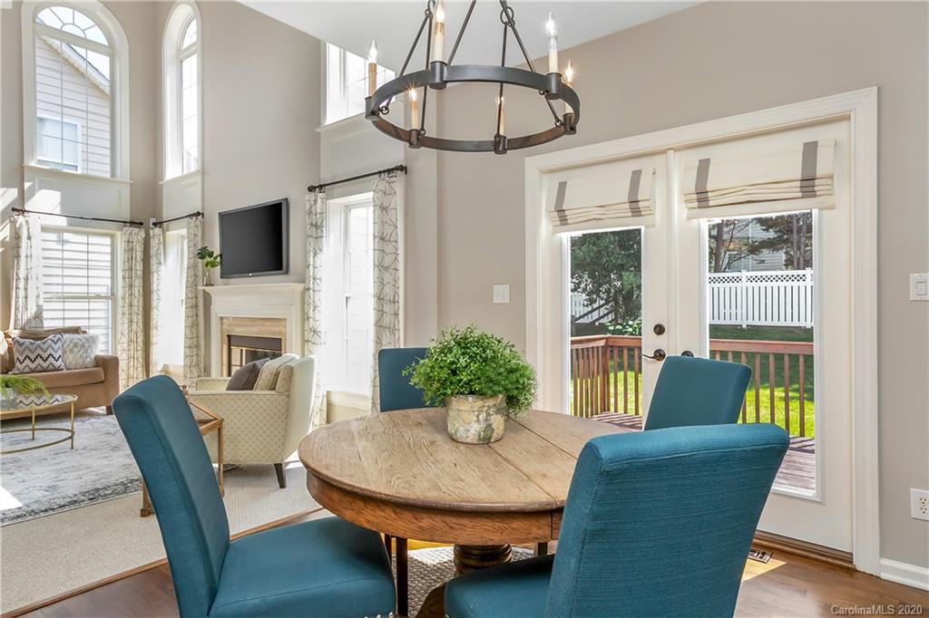 6523 Elfreda Road Charlotte, NC 28270 - Photo 14 of 29 a living room with furniture a dining table and a chandelier
