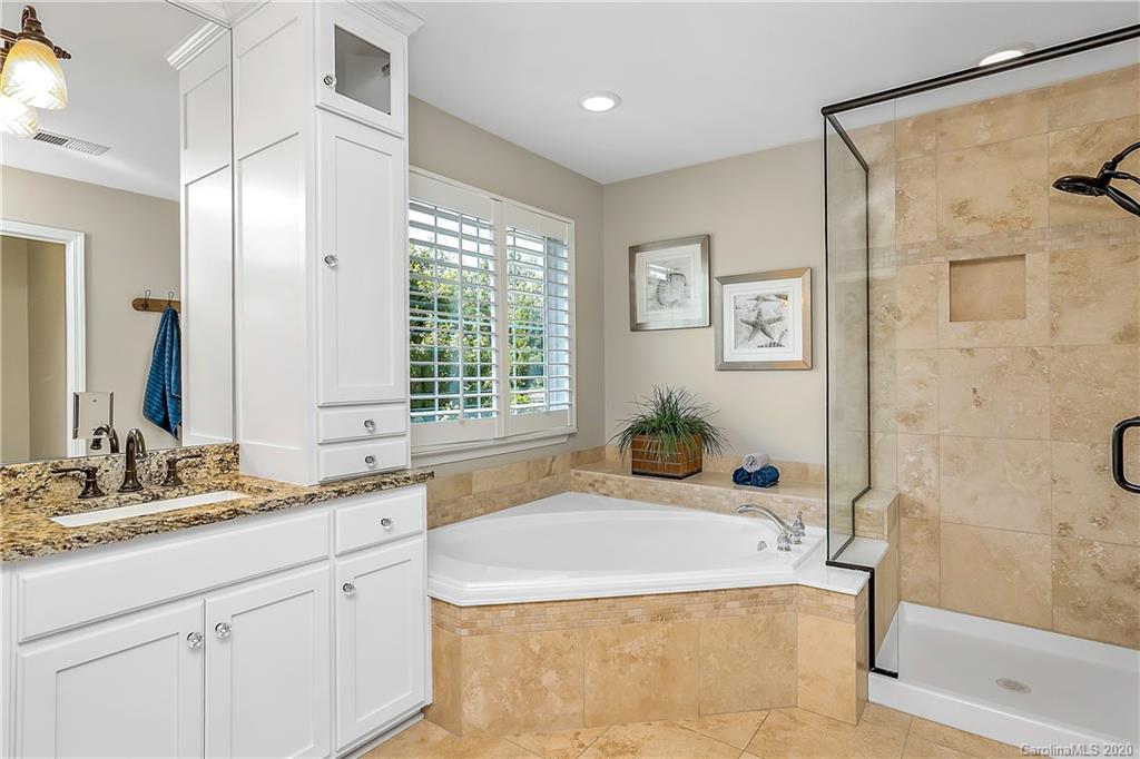 6523 Elfreda Road Charlotte, NC 28270 - Photo 22 of 29 a bathroom with a granite countertop sink mirror and a bathtub