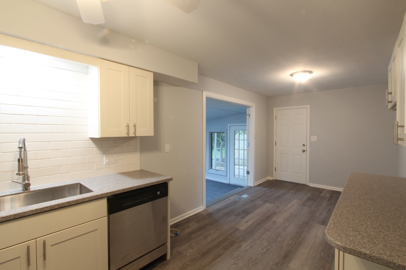 703 Sheridan Road Normal, IL 61761 - Photo 6 of 15 a kitchen with granite countertop white cabinets and a wooden floor