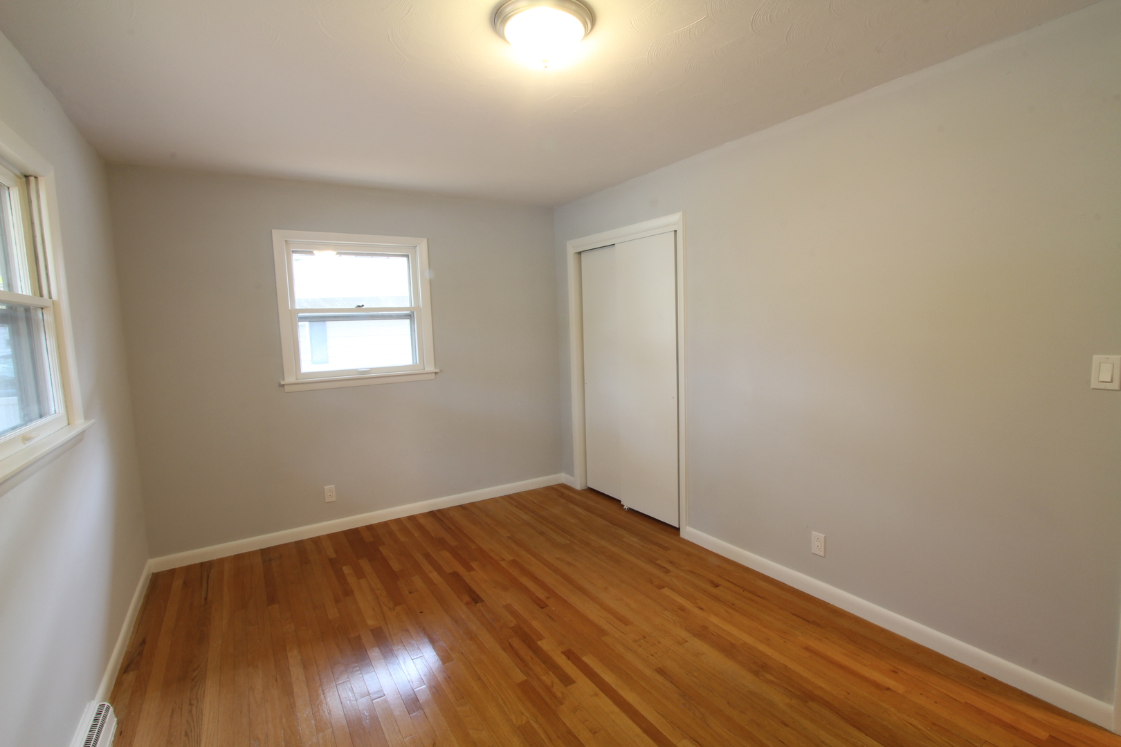 703 Sheridan Road Normal, IL 61761 - Photo 9 of 15 an empty room with wooden floor and windows