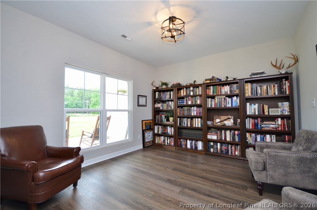 1865 John B Carter Road Fayetteville, NC 28312 - Photo 3 of 49 a living room with furniture and a book shelf