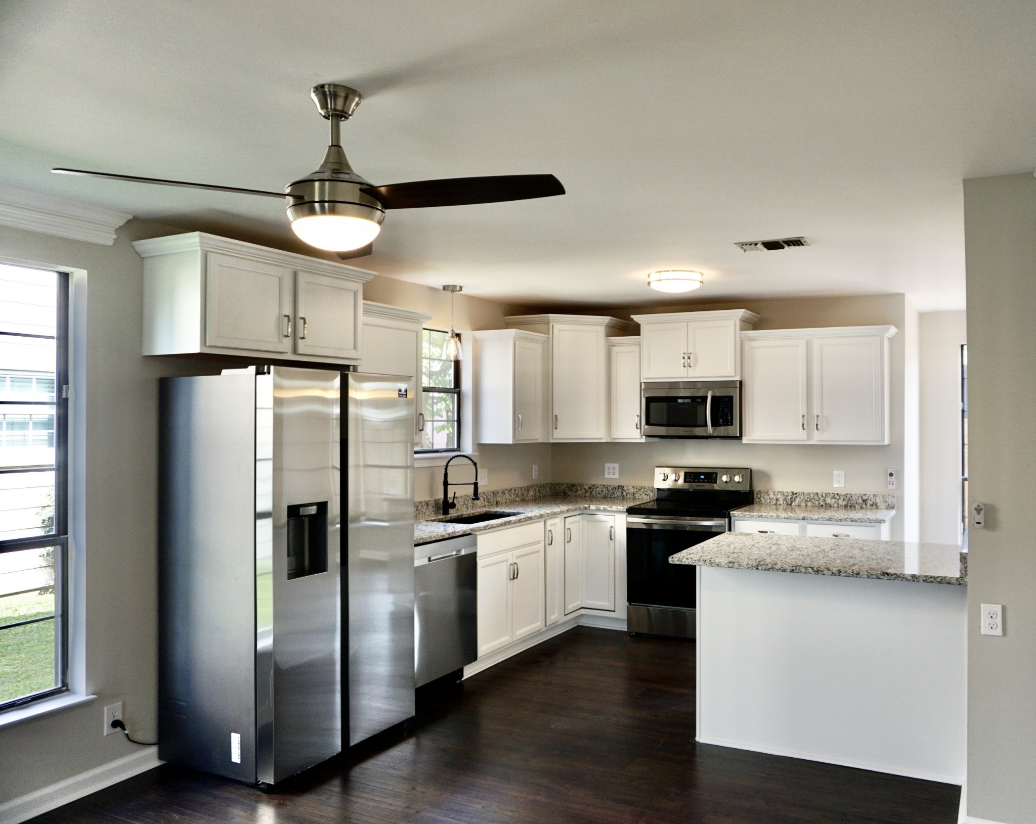 1215 General George Patton Road Nashville, TN 37221 - Photo 3 of 18 a kitchen with stainless steel appliances a refrigerator a stove a sink and white cabinets