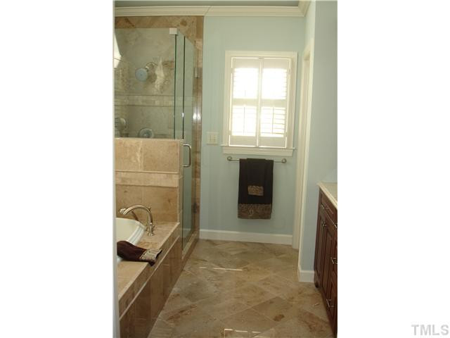 1921 Torrington Street Raleigh, NC 27615 - Photo 15 of 25 Everything has been renovated! Heated tile floors, new shower surround and fixtures, and a cathedral ceiling make this bathroom an oasis!