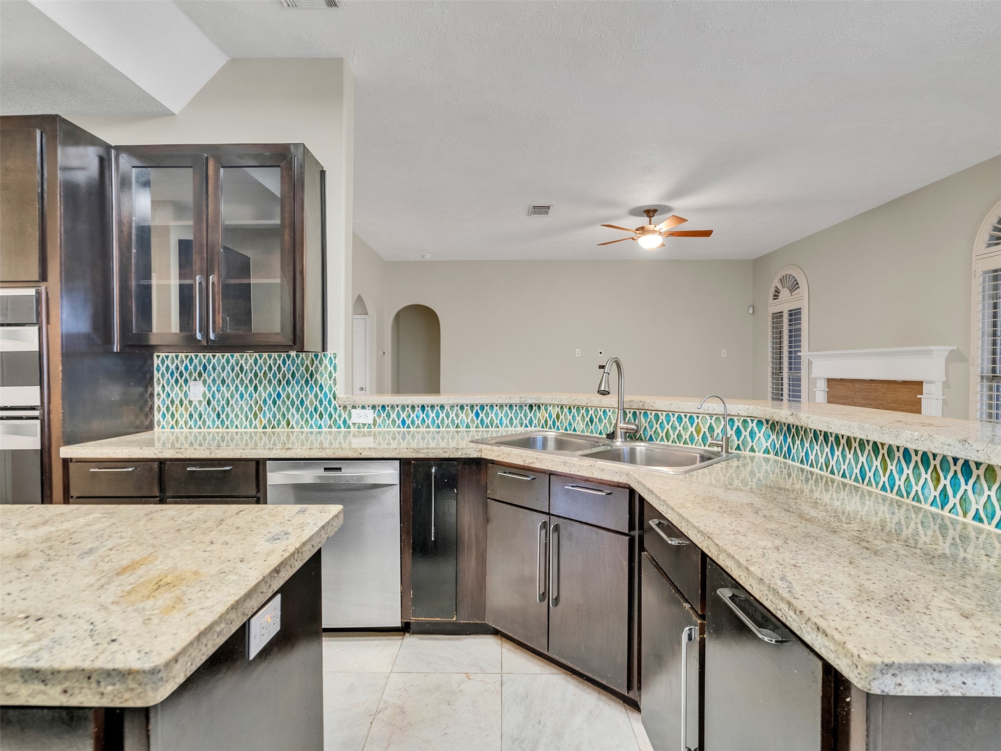 4414 Santee Drive Baytown, TX 77521 - Photo 13 of 50 a kitchen with a stove a sink and a wooden cabinets